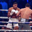 Britain's Anthony Joshua (L) looks for an opening against Ukraine's Wladimir Klitschko during the third round of their IBF, IBO and WBA, world heavyweight title fight, at Wembley Stadium in London, on April 29, 2017