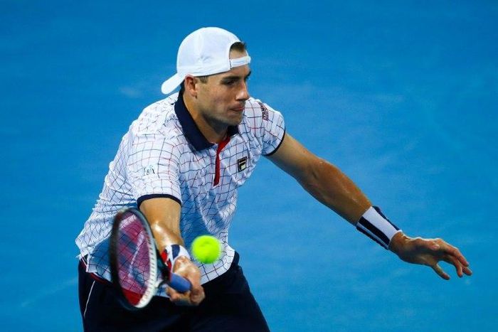 The US' John Isner hits a return to Australia's Nick Kyrgios in the world group quarter-final Davis Cup tennis match between Australia and the USA
