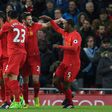 Liverpool's midfielder Roberto Firmino (L) celebrates with teammates after scoring the opening goal of the English Premier League football match against Arsenal March 4, 2017