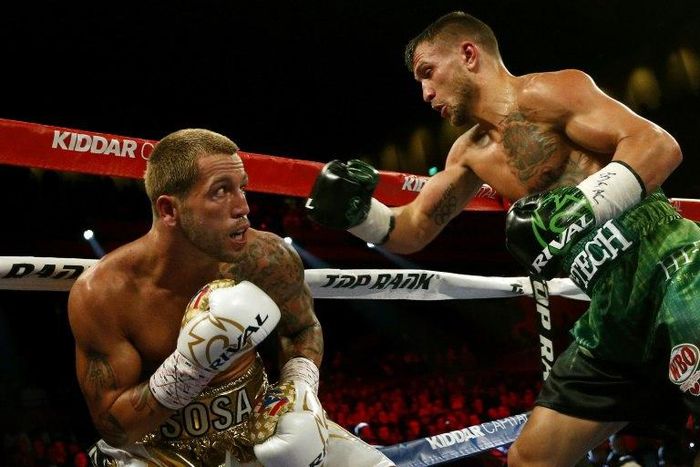 Jason Sosa (L) of the US exchanges punches with Vasyl Lomachenko of Ukraine during their WBO super featherweight world championship bout, at MGM National Harbor in Oxon Hill, Maryland, on April 8, 2017