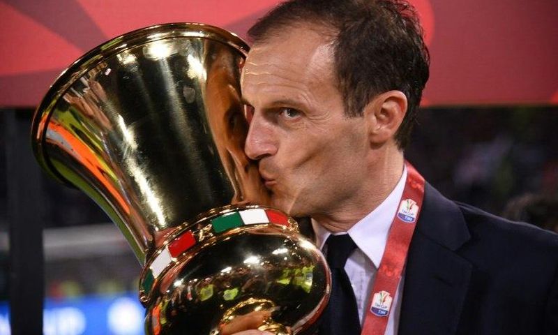 Juventus' coach from Italy Massimiliano Allegri kisses the trophy after winning the Italian Tim Cup final on May 17, 2017 at the Olympic stadium in Rome