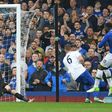 Everton's striker Romelu Lukaku (R) scores past Leicester City's goalkeeper Kasper Schmeichel (L) during the English Premier League football match between Everton and Leicester City at Goodison Park in Liverpool, north west England on April 9, 2017