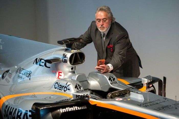 Sahara Force India team principal Vijay Mallya takes a picture of the VJM10 car at a launch event at the Silverstone motor racing circuit near Towcester, central England on February 22, 2017