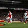 Arsenal's midfielder Mesut Ozil (2nd R) watches as his shot beats West Ham United's goalkeeper Darren Randolph (L) for the opening goal of the English Premier League football match between Arsenal and West Ham United on April 5, 2017