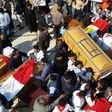 Egyptian clergymen and officials carry the coffins of the victims of a church bombing in Cairo, on December 12, 2016