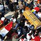Egyptian clergymen and officials carry the coffins of the victims of a church bombing in Cairo, on December 12, 2016
