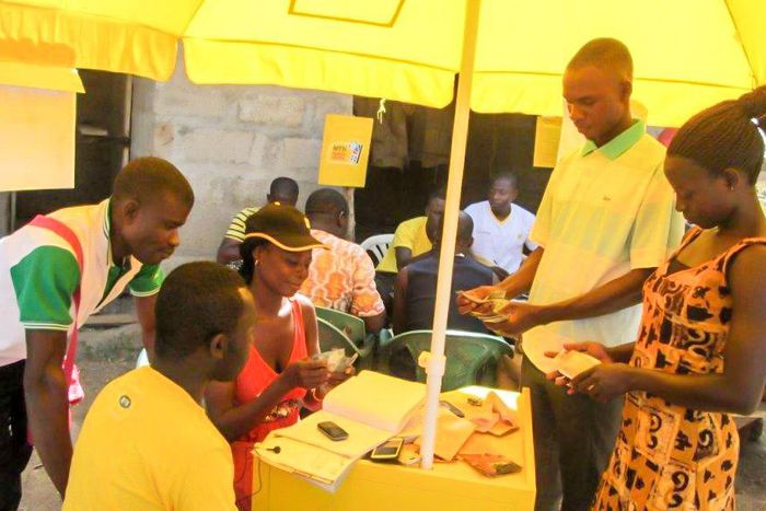 ___5476222___https:______static.pulse.com.gh___webservice___escenic___binary___5476222___2016___9___9___23___Beneficiaries-of-the-mobile-money-service-carrying-out-a-transaction-2