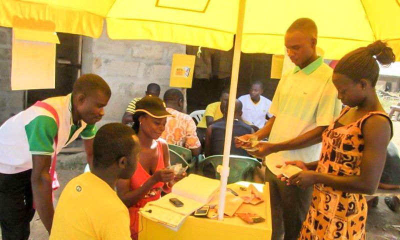 ___5476222___https:______static.pulse.com.gh___webservice___escenic___binary___5476222___2016___9___9___23___Beneficiaries-of-the-mobile-money-service-carrying-out-a-transaction-2