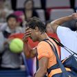 Rafael Nadal of Spain (left) walks off court after defeat by Serbia's Viktor Troicki at the Shanghai Masters on October 12, 2016
