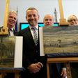 Axel Ruger (C), Director of the Van Gogh museum, poses next to recovered stolen paintings by Vincent Van Gogh entitled "Congregation Leaving the Reformed Church in Nuenen" (L) and "The Beach At Scheveningen During A Storm" (R) in Naples in 2016