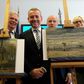 Axel Ruger (C), Director of the Van Gogh museum, poses next to recovered stolen paintings by Vincent Van Gogh entitled "Congregation Leaving the Reformed Church in Nuenen" (L) and "The Beach At Scheveningen During A Storm" (R) in Naples in 2016
