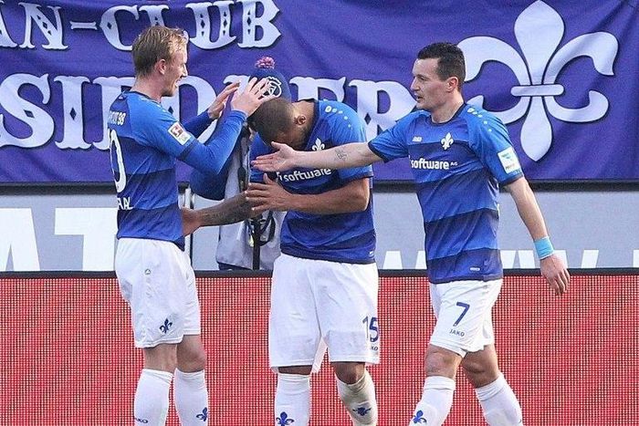 Darmstadt's defender Junior Diaz (C) celebrates scoring during the German first division Bundesliga football match against Borussia Dortmund February 11, 2017