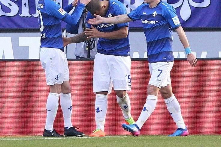 Darmstadt's defender Junior Diaz (C) celebrates scoring during the German first division Bundesliga football match against Borussia Dortmund February 11, 2017