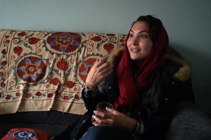 Afghan swimmer and coach Elena Saboori, head of the newly created Women's Swimming Committee, gestures as she speaks during an interview with AFP in a house in Kabul