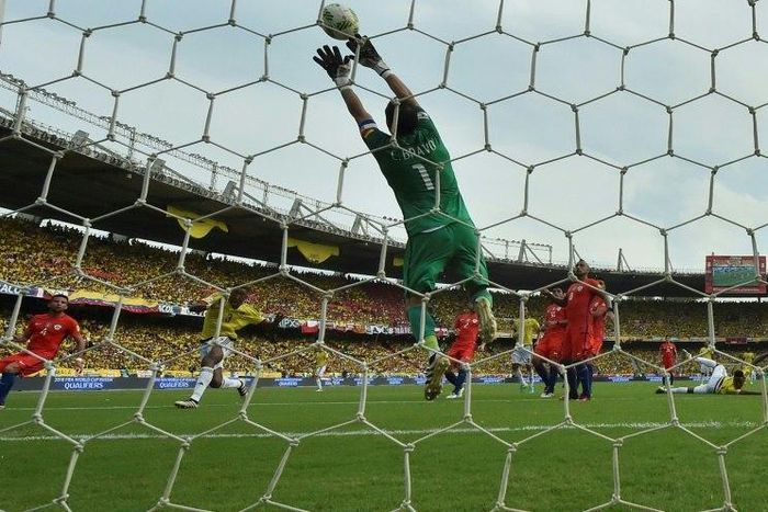 Chile's goalkeeper Claudio Bravo pulls off a save during the 2018 FIFA World Cup qualifier football match against Colombia in Barranquilla, Colombia, on November 10, 2016