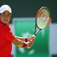 Kei Nishikori of Japan plays a backhand against Gilles Muller of Luxembourg in their third round match during day nine of the BNP Paribas Open at Indian Wells Tennis Garden on March 14, 2017