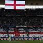 England and French players stand during a minute's silence ahead of the international friendly football match at the Stade de France stadium near Paris on June 13, 2017