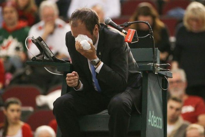 Chair umpire Arnaud Gabas reacts to getting hit in the eye with a ball hit by Denis Shapovalov of Canada on February 5, 2017