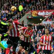 Arsenal's French striker Olivier Giroud heads the ball to score their third goal during the English Premier League football match between Sunderland and Arsenal at the Stadium of Light in Sunderland, northeast England on October 29, 2016