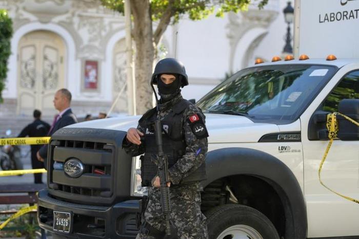 A member of the Tunisian security forces stands guard at the site of a suicide attack in the capital Tunis on October 29, 2018
