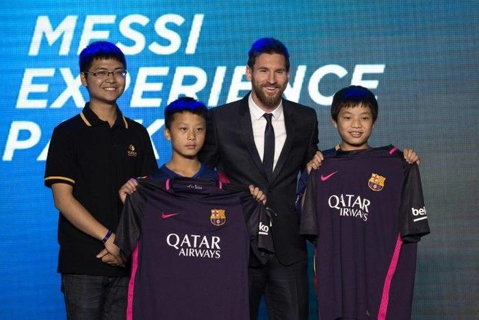 Barcelona's forward Lionel Messi poses for a photo with Chinese fans in Beijing on June 1, 2017