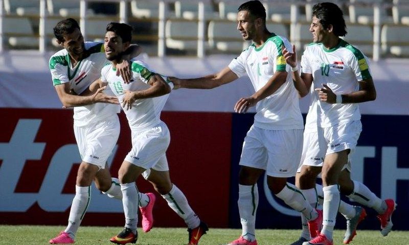Iraqi players celebrate scoring against Japan during a 2018 World Cup qualifier in the Iranian capital Tehran on June 13, 2017