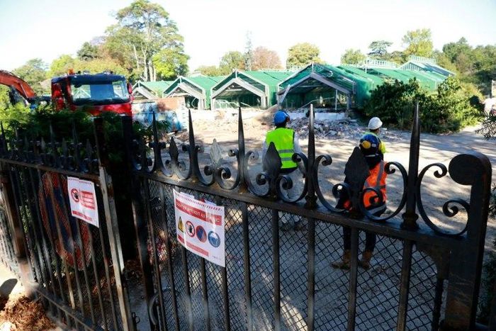Workers supervise the destruction of greenhouses in the Auteuil botanical garden in Paris, on October 5, 2016 in order to allow the construction of a new stadium for Roland Garros