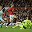 Burnley's goalkeeper Tom Heaton (R) saves a shot from Manchester United's striker Zlatan Ibrahimovic (C) during the English Premier League football match between Manchester United and Burnley on October 29, 2016