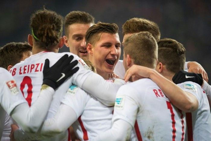 Leipzig's defender Willi Orban celebrates with teamates after scoring his team's third goal against Hertha BSC Berlin in Leipzig, eastern Germany on December 17, 2016