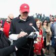 Former San Francisco 49ers wide receiver Dwight Clark signs autographs for fans during the 4th Annual Chevron Charity Shoot-Out at Pebble Beach Golf Links in California, in 2014