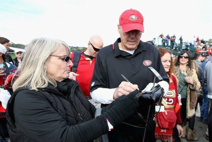Former San Francisco 49ers wide receiver Dwight Clark signs autographs for fans during the 4th Annual Chevron Charity Shoot-Out at Pebble Beach Golf Links in California, in 2014