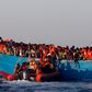 A rescue boat of the Spanish NGO Proactiva approaches an overcrowded wooden vessel with migrants from Eritrea, off the Libyan coast in Mediterranean Sea August 29, 2016.