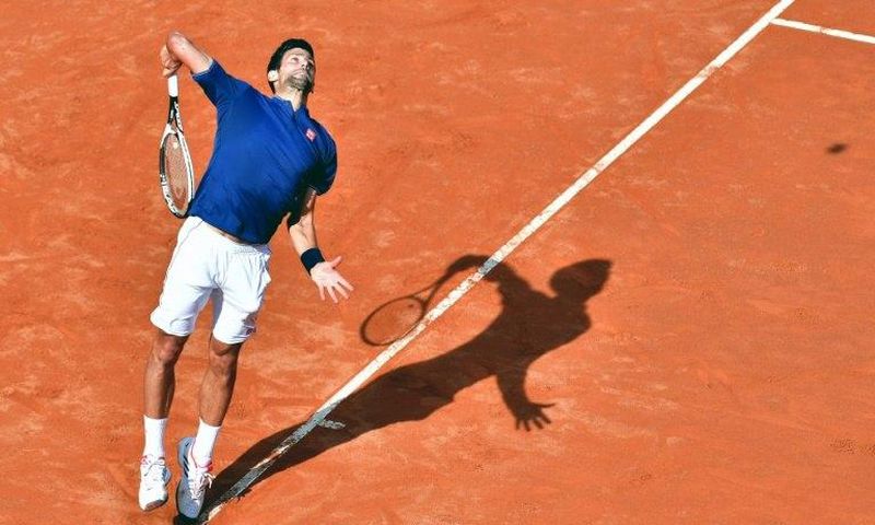 Novak Djokovic of Serbia serves to Roberto Bautista during their third round match at the ATP Tennis Open tournament on May 18, 2017 at the Foro Italico in Rome, Italy