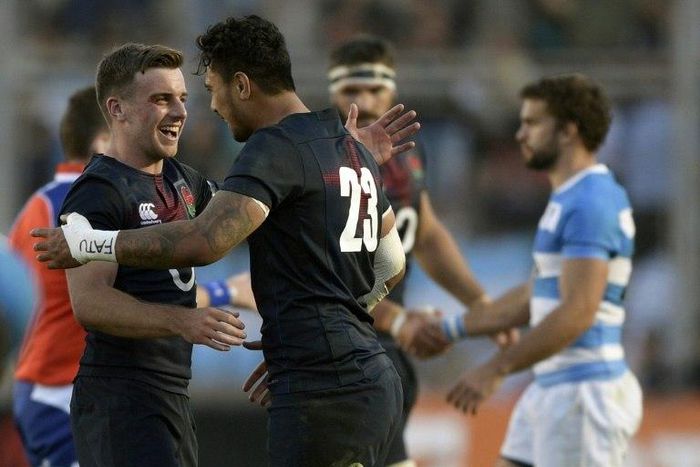 England's fly-half George Ford (L) and Denny Solomona (C) celebrate after defeating Argentina's Los Pumas during their Rugby Union test match June 10, 2017