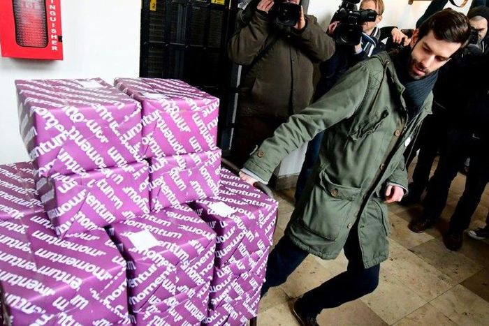 Leader of the political movement Momentum Andras Fekete-Gyor pulls a cart with more than 260,000 signatures of voters for a referendum on Budapest's bid to host the 2024 Summer Olympics in the city hall of the Hungarian capital on February 17, 2017