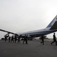 Rwandan troops who have returned from the Sudan's Darfur region walk past the U.S. Air Force One at Kigali International airport, file.