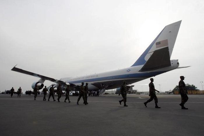 Rwandan troops who have returned from the Sudan's Darfur region walk past the U.S. Air Force One at Kigali International airport, file.