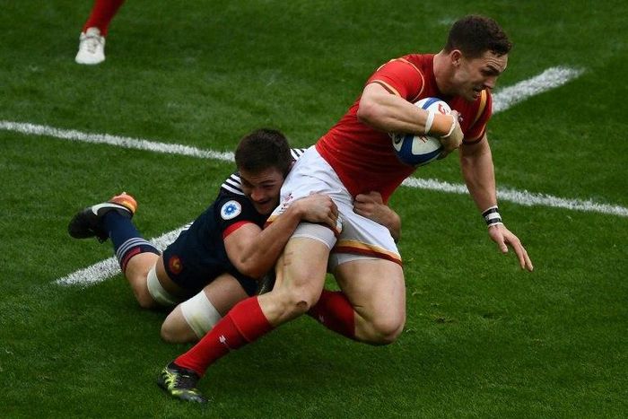 France's fullback Brice Dulin (L) tackles Wales' wing George North on March 18, 2017
