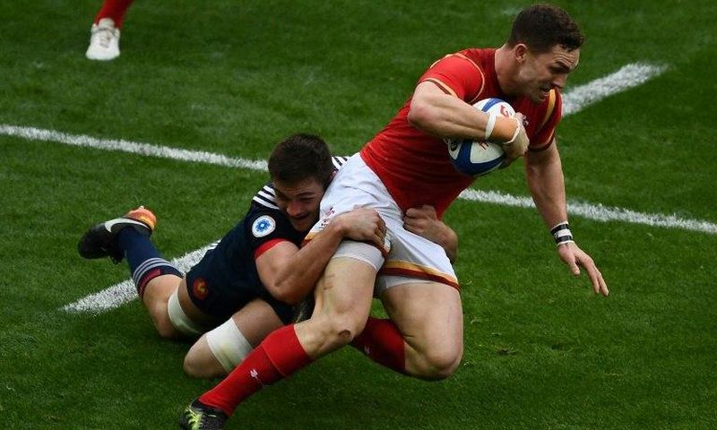 France's fullback Brice Dulin (L) tackles Wales' wing George North on March 18, 2017