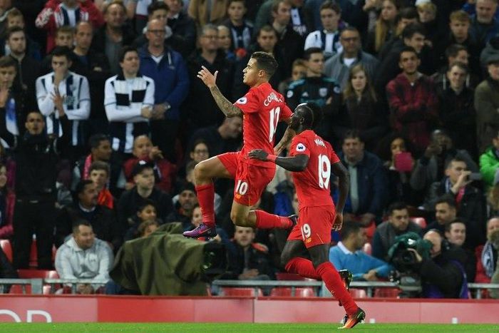 Liverpool's midfielder Philippe Coutinho (L) celebrates scoring their second goal with Liverpool's midfielder Sadio Mane (R) during the English Premier League football match between Liverpool and West Bromwich Albion on October 22, 2016