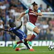 West Ham striker Andy Carroll (R) is tackled by Chelsea's midfielder N'Golo Kante during the English Premier League match at Stamford Bridge in London on August 15, 2016