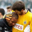 Partizan Belgrade's goalkeeper Filip Kljajic (right) hugs Everton Luiz as he leaves the field in tears on February 19, 2017