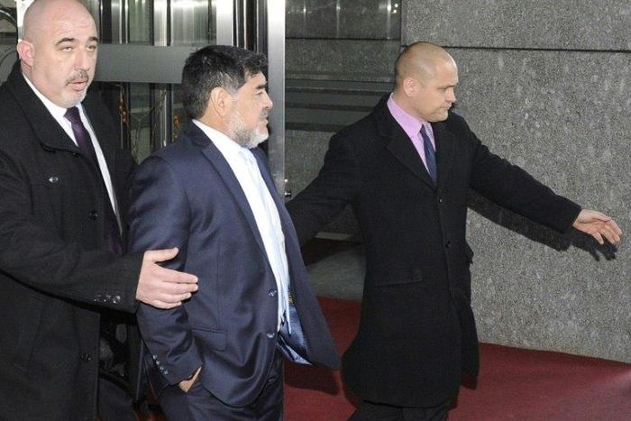 Former Argentinian footballer Diego Armando Maradona (centre) leaves the Mirasierra Hotel in Madrid, on February 15, 2017