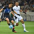 Japan forward Shinji Okazaki (L) is tracked by Thailand's Koravit Namwiset during World Cup 2018 group B qualifying match in Saitama on March 28, 2017