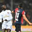 AC Milan's forward M'Baye Niang (L) fights for the ball with Genoa's defender Ezequiel Munoz during the Italian Serie A football match October 25, 2016
