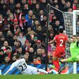 Swansea midfielder Gylfi Sigurdsson (L) slides the ball past Liverpool goalkeeper Simon Mignolet (R) to score the winning goalin the English Premier League match at Anfield in Liverpool, north-west England on January 21, 2017