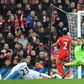 Swansea midfielder Gylfi Sigurdsson (L) slides the ball past Liverpool goalkeeper Simon Mignolet (R) to score the winning goalin the English Premier League match at Anfield in Liverpool, north-west England on January 21, 2017