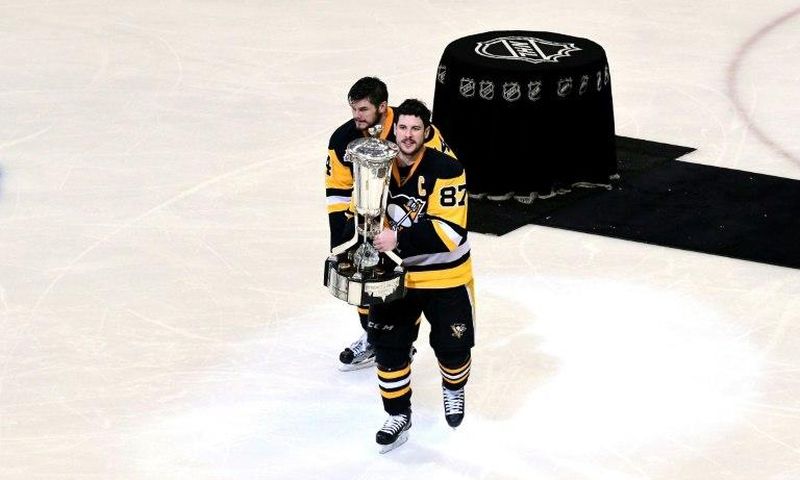 Sidney Crosby (R) and Chris Kunitz of the Pittsburgh Penguins celebrate with the Prince of Wales Trophy after winning Game Seven of the NHL Eastern Conference Finals against the Ottawa Senators, in Pittsburgh, Pennsylvania, on May 25, 2017