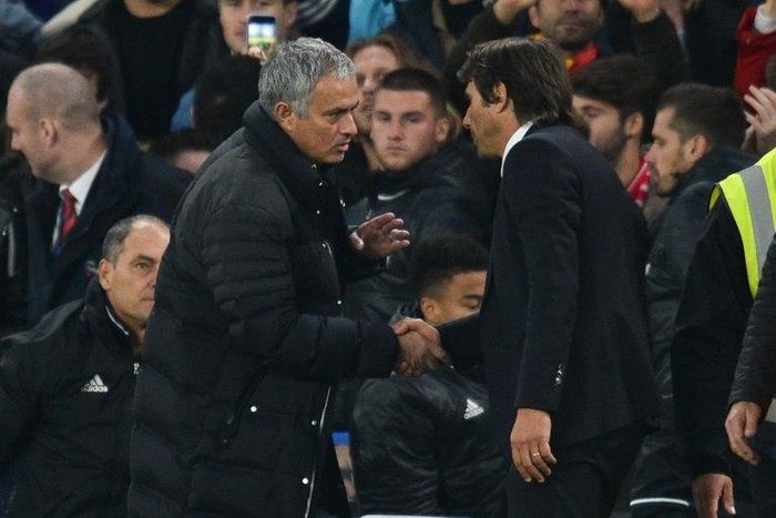 Manchester United's manager Jose Mourinho (L) shakes hands with Chelsea's head coach Antonio Conte after the final whistle at Stamford Bridge in London on October 23, 2016