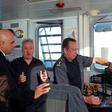 Britain's Home Secretary Sajid Javid (L) talks with UK Border Force staff onboard of Border Force cutter, HMC Searcher, on the Dover Strait off the coast of Dover, in south-east England